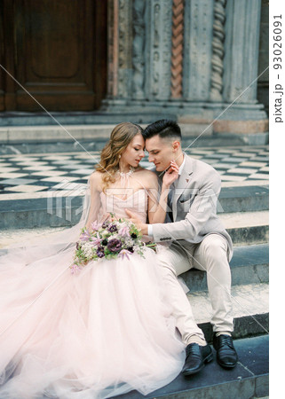Bride and groom sit on the steps. Bergamo, Italy 93026091