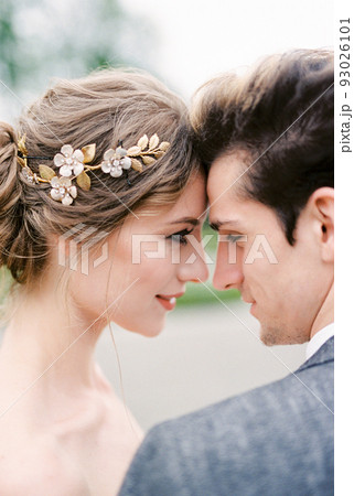 Groom touches the forehead of bride with his forehead. Portrait Groom touches the forehead of bride with his forehead. Portrait 93026101