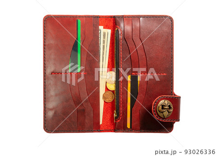 Open red leather clutch with money and credit cards 93026336