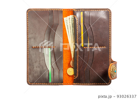 Open red leather clutch with money and credit cards 93026337