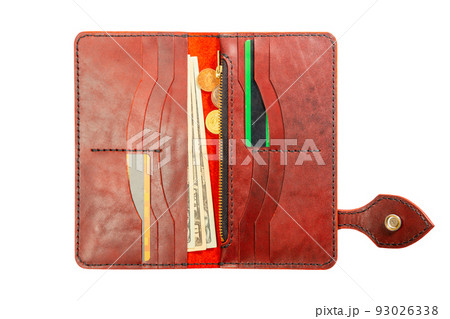 Open red leather clutch with money and credit cards 93026338