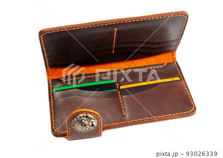 Open red leather clutch with money and credit cards 93026339