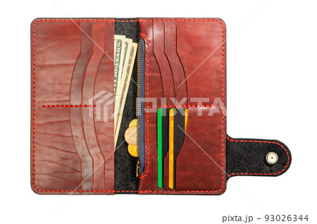 Open red leather clutch with money and credit cards 93026344