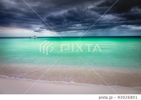 Dramatic sky over beach with motorboat, Negril Seven Mile Beach, Jamaica 93026801