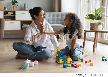 Happy beautiful Indian mom and little daughter girl clapping hands Happy beautiful Indian mom and little daughter girl clapping hands 93028146