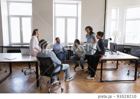Six friendly multi-ethnic office employees talk during group meeting Six friendly multi-ethnic office employees talk during group meeting 93028210