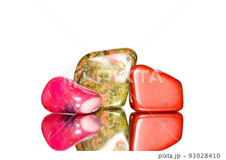 Three colorful gemstones on white background with mirror reflection.	 93028410