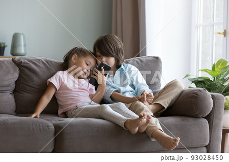 Cute preschoolers kids using smartphone at home Cute preschoolers kids using smartphone at home 93028450