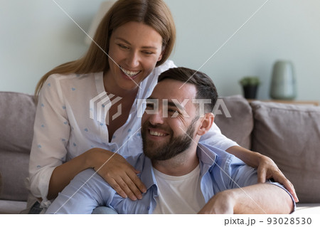 Close up cheerful couple hugging laughing at home 93028530
