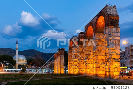 Selcuk cityscape with ruined Roman aqueduct in evening, Turkey 93031128