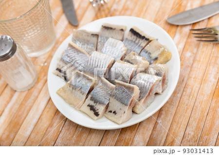 Pieces of herring served on plate Pieces of herring served on plate 93031413