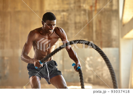 Sport. Strong man exercising with battle ropes at the gym with. Athlete  doing battle rope workout at Stock Photo by Gerain0812