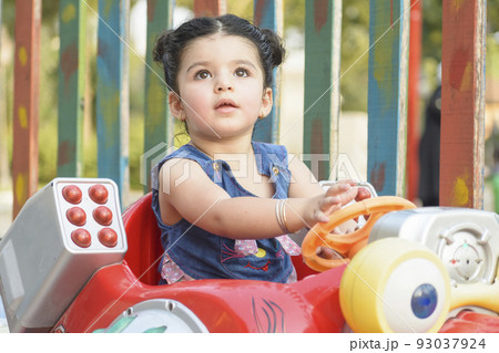 Little girl having fun on musical coin machine 93037924