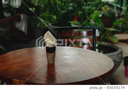 An empty table and chair at a tropical garden An empty table and chair at a tropical garden 93039274