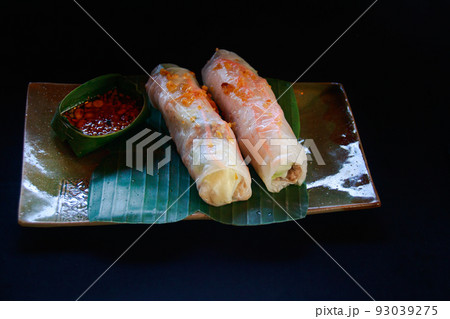 Khmer fresh rice paper spring rolls called num naem chhao served in a ceramic platter Khmer fresh rice paper spring rolls called num naem chhao served in a ceramic platter 93039275