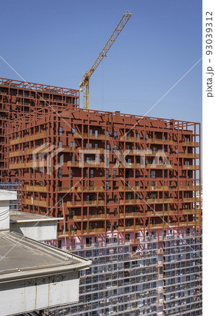 Albania, May 12, 2022 - Construction crane on top of unfinished building Albania, May 12, 2022 - Construction crane on top of unfinished building 93039312