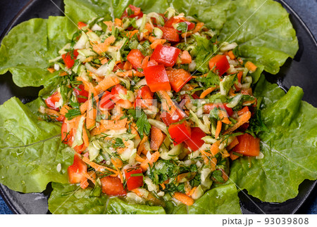 Plate of salad with vegetables and greens on a dark concrete table 93039808