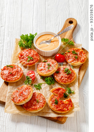 mini pizzas with ham and pecorino cheese, top view 93039876