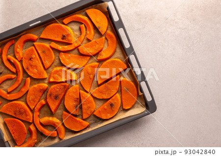 Baked sweet pumpkin on a baking sheet Baked sweet pumpkin on a baking sheet 93042840