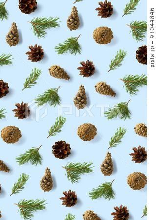 Pine cone Christmas background on blue. Pine branches and cones. minimal creative cone arrangement pattern. flat lay, Modern christmas Background. Pine cone Christmas background on blue. Pine branches and cones. minimal creative cone arrangement pattern. flat lay, Modern christmas Background. 93044846