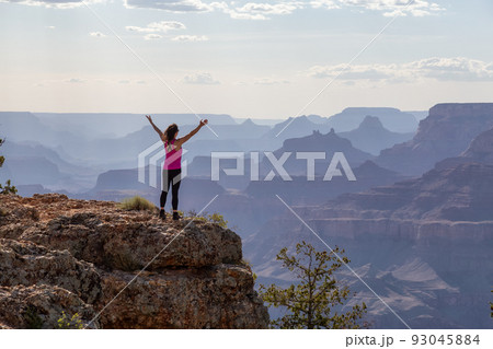 Adventurous Traveler standing on Desert Rocky Mountain American Landscape 93045884