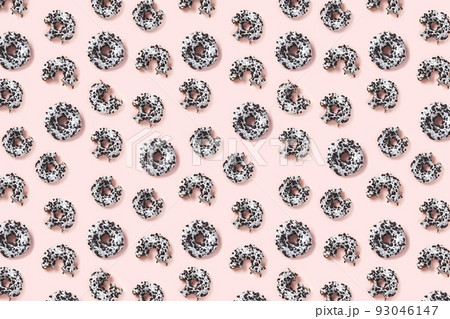 donuts on a pink background top view. Flat lay of delicious nibbled chocolate donuts. used as donut banner or poster background, not pattern. donuts on a pink background top view. Flat lay of delicious nibbled chocolate donuts. used as donut banner or poster background, not pattern. 93046147