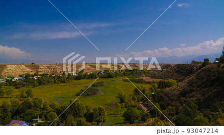 aerial panorama view to Karakol towm, formerly Przhevalsk, and Issyk-Kul lake, Kyrgyzstan 93047214