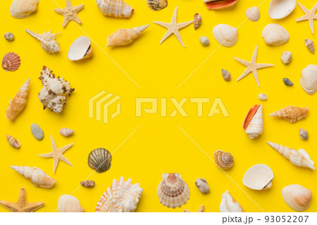 Summer time concept Flat lay composition with beautiful starfish and sea shells on colored table, top view with copy space for text 93052207