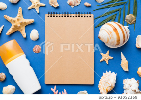 Blank writing book with summer beach accessories on background, copy space. Flat lay with copy space Blank writing book with summer beach accessories on background, copy space. Flat lay with copy space 93052369
