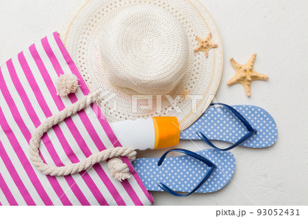 beach accessories flat lay top view on colored background Summer travel concept. Bag with starfish and sea shell. Top view beach accessories flat lay top view on colored background Summer travel concept. Bag with starfish and sea shell. Top view 93052431