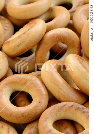 Close-up photo of fresh yellow bagels. A popular kind of flour products. One of the traditional Russian treats for tea 93052848