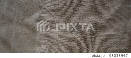 The texture of a very old brown sack cloth. Retro texture with canvas material. Background image with copy space 93053947