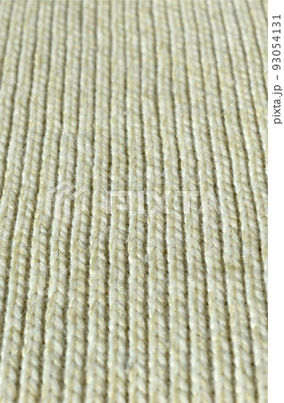 Fabric texture of a soft yellow knitted sweater. Macro image of the structure of bindings in yarns Fabric texture of a soft yellow knitted sweater. Macro image of the structure of bindings in yarns 93054131