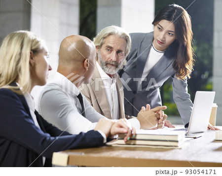 multiethnic team of corporate executives meeting in office multiethnic team of corporate executives meeting in office 93054171
