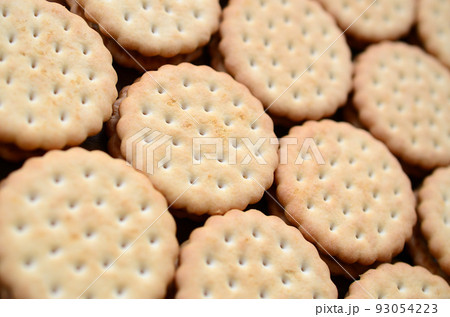 Detailed picture of round sandwich cookies with coconut filling. Background image of a close-up of several treats for tea Detailed picture of round sandwich cookies with coconut filling. Background image of a close-up of several treats for tea 93054223