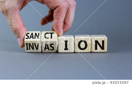 Sanction against invasion symbol. Businessman turns cubes and changes the concept word Invasion to Sanction. Beautiful grey background. Business sanction against invasion concept. Copy space. 93055097
