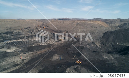 Truck traffic in huge coal mine. Yellow dump trucks moving towards each other. Aerial view 93057433