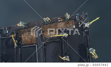 Camera takeoff over mountains of coal on seaport territory 93057441