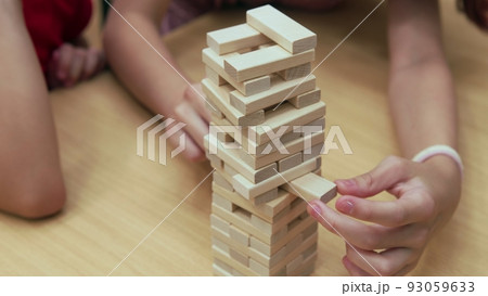 4K. Children play a board game in the library 93059633