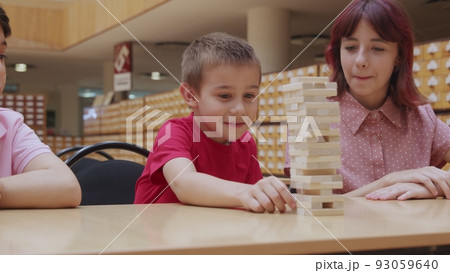 4K. Children play a board game in the library 4K. Children play a board game in the library 93059640
