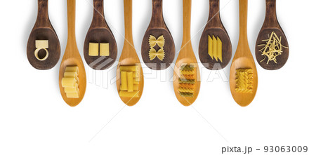 Wooden cooking spoons filled with various types dry pasta Wooden cooking spoons filled with various types dry pasta 93063009