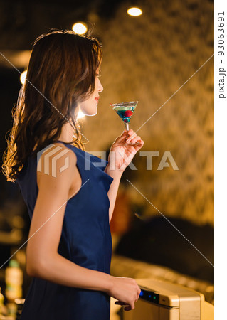バーでカクテルを飲む美女 93063691