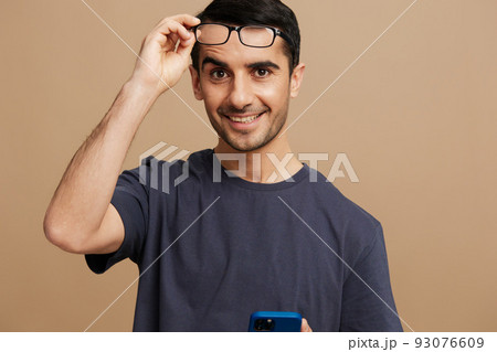 portrait man glasses posing fashion self-confidence beige background 93076609