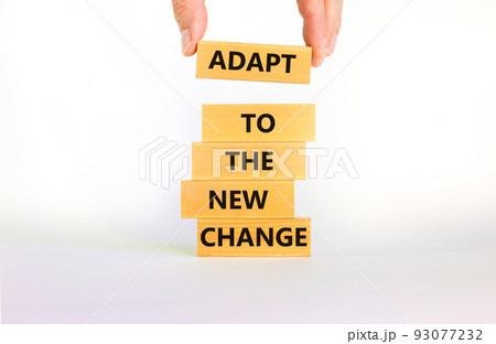 Adapt to the new change symbol. Wooden blocks with words Adapt to the new change on beautiful white background, copy space. Businessman hand. Business, adapt to change concept. Adapt to the new change symbol. Wooden blocks with words Adapt to the new change on beautiful white background, copy space. Businessman hand. Business, adapt to change concept. 93077232