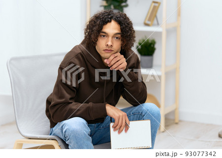 portrait of a man writing down ideas with a notepad light background 93077342
