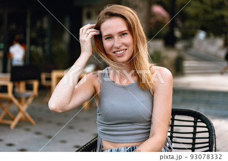 Portrait of a young beautiful woman in the summer city 93078332
