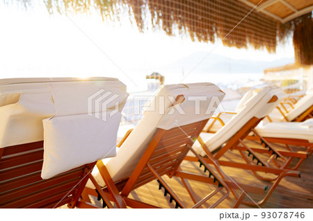 Empty deck chairs with white mattresses in resort hotel 93078746