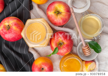 Jewish holiday Rosh Hashanah background with honey and apples on wooden table. Jewish holiday Rosh Hashanah background with honey and apples on wooden table. 93078958