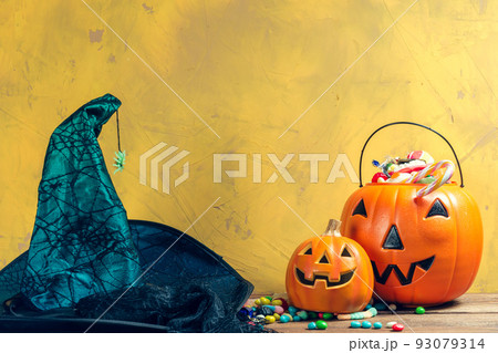 Happy halloween! Pumpkin with candy in the home. 93079314