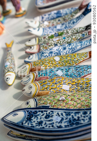 Stall with colorful Portuguese ceramic sardines Stall with colorful Portuguese ceramic sardines 93080562